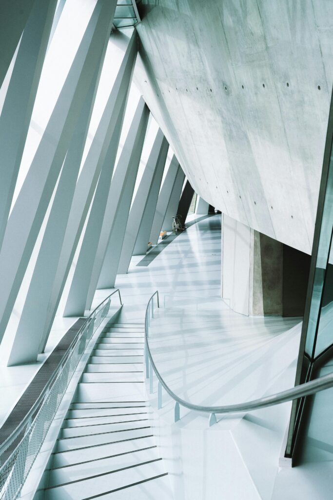 Sleek and modern architectural staircase in a futuristic office building with angular design.